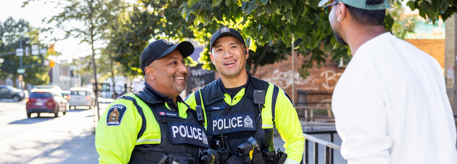 Two officers speaking with citizen on sidewalk